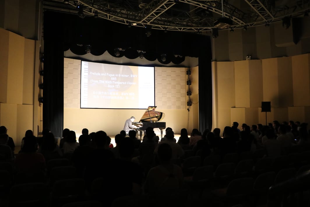 David Chang performing solo piano recital in front of large audience