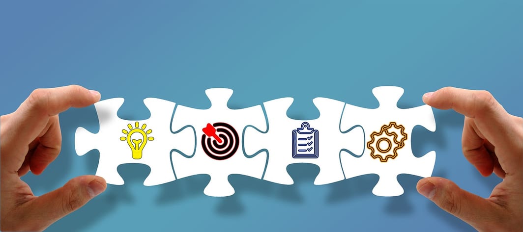 four large puzzle pieces with strategy-related icons